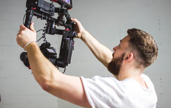 Man holding camera filming video