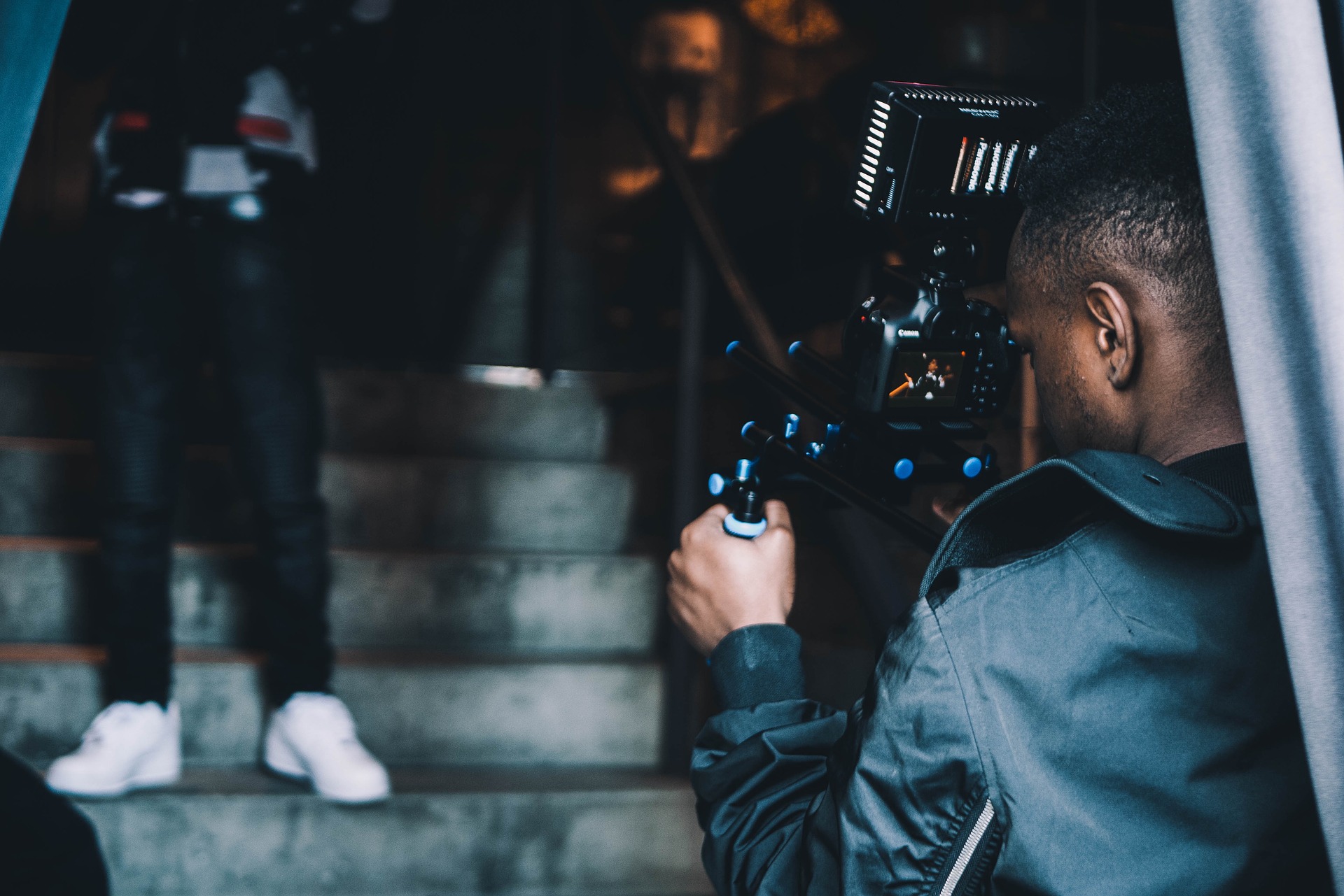 Man holding camera filming video